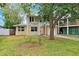 Two-story home with white and yellow siding, a well-maintained lawn, and an attached single-car garage at 1810 Maryland Ne Ave, St Petersburg, FL 33703