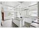 Open kitchen with coffered ceilings, custom island, and sleek, white cabinetry plus stainless steel appliances at 1810 Maryland Ne Ave, St Petersburg, FL 33703