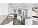 Open kitchen with coffered ceilings, custom island, stainless steel appliances, and sleek, white cabinetry at 1810 Maryland Ne Ave, St Petersburg, FL 33703