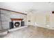 Spacious living room showcasing a stone fireplace with wood mantle and tile flooring at 1810 Maryland Ne Ave, St Petersburg, FL 33703