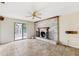 Living room with stone fireplace, sliding glass door, and tile flooring at 1810 Maryland Ne Ave, St Petersburg, FL 33703