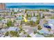 Aerial view of a charming coastal home located near a beautiful beach with bright blue skies at 18198 3Rd E St, Redington Shores, FL 33708