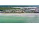 Beach community aerial view features condos, parking, and a sandy beach on a sunny day at 18198 3Rd E St, Redington Shores, FL 33708