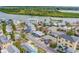 Bright aerial shot of a quiet residential neighborhood near a beautiful, lush green area at 18198 3Rd E St, Redington Shores, FL 33708