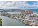 Waterfront community view with boat docks, swimming pool, and condos on a sunny day at 18198 3Rd E St, Redington Shores, FL 33708