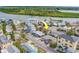 Bright aerial shot of neighborhood with well-maintained homes and tropical palm trees at 18198 3Rd E St, Redington Shores, FL 33708