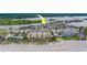 Beach community aerial view features condos, parking, and a sandy beach on a sunny day at 18198 3Rd E St, Redington Shores, FL 33708