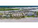 Beach community aerial view features condos, parking, and a sandy beach on a sunny day at 18198 3Rd E St, Redington Shores, FL 33708