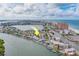 Waterfront community view with boat docks, swimming pool, and condos on a sunny day at 18198 3Rd E St, Redington Shores, FL 33708