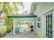Cozy back patio with brick pavers, grill and casual seating nestled among swaying palm trees at 18198 3Rd E St, Redington Shores, FL 33708