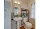 Powder room with a pedestal sink, mosaic backsplash and stylish fixtures at 18198 3Rd E St, Redington Shores, FL 33708