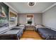 Shared bedroom featuring two twin beds, study area, and wood floors at 18198 3Rd E St, Redington Shores, FL 33708