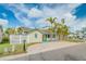 Lovely home with a charming exterior, a manicured lawn, and mature palm trees adding tropical flair at 18198 3Rd E St, Redington Shores, FL 33708