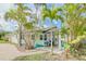 Delightful home featuring a charming exterior, a beautiful front yard, and a cozy outdoor seating area at 18198 3Rd E St, Redington Shores, FL 33708