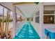 Inviting front porch with blue floors, offering a cozy spot to relax and enjoy waterfront breezes and stunning views at 18198 3Rd E St, Redington Shores, FL 33708
