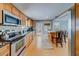Modern kitchen with stainless steel appliances, granite countertops, and a breakfast bar island with seating at 18198 3Rd E St, Redington Shores, FL 33708