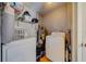 Utility room equipped with a washer, dryer, water heater, and ample storage at 18198 3Rd E St, Redington Shores, FL 33708