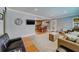 Open-concept living room showcasing seamless transition to the kitchen with wood floors and neutral decor at 18198 3Rd E St, Redington Shores, FL 33708
