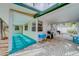 Covered outdoor patio with a grill and a cozy seating area, perfect for entertaining and relaxing by the barbeque at 18198 3Rd E St, Redington Shores, FL 33708