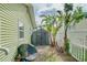 Side yard with convenient storage shed, lush landscaping and a traditional white picket fence at 18198 3Rd E St, Redington Shores, FL 33708