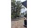 View of backyard, showing mature landscaping, a shed, and an installed HVAC unit at 2312 W Kenmore Ave, Tampa, FL 33604