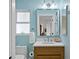 A bright bathroom with a modern vanity, neutral countertops, and stylish lighting fixtures at 243 Hermosita Dr, St Pete Beach, FL 33706