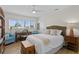Bright bedroom with wooden floors, stylish furnishings, and natural light from shuttered windows at 243 Hermosita Dr, St Pete Beach, FL 33706