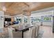 Spacious dining and living room with wood ceiling, an open layout, and waterfront views at 243 Hermosita Dr, St Pete Beach, FL 33706