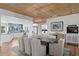 Open-concept kitchen and dining area with a long wood table and view of the water at 243 Hermosita Dr, St Pete Beach, FL 33706
