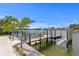 A private dock with a boat lift provides direct access to the water for boating and water activities at 243 Hermosita Dr, St Pete Beach, FL 33706