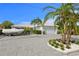 Charming one-story home featuring a paver driveway, two-car garage, boat and lush landscaping at 243 Hermosita Dr, St Pete Beach, FL 33706
