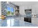 Stylish kitchen featuring blue countertops, a mosaic backsplash, and plenty of natural light at 243 Hermosita Dr, St Pete Beach, FL 33706