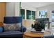 Cozy living room nook with comfortable armchairs, grand piano, and picturesque views of the water at 243 Hermosita Dr, St Pete Beach, FL 33706