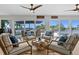 A stylish living room offers serene water views through large sliding glass doors and comfortable seating at 243 Hermosita Dr, St Pete Beach, FL 33706