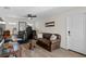 Comfortable living room with leather sofa, ceiling fan, and view of the boat-themed wall decor at 243 Hermosita Dr, St Pete Beach, FL 33706