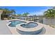 A gorgeous pool and jacuzzi overlook the waterfront, with ample space for entertaining at 243 Hermosita Dr, St Pete Beach, FL 33706