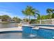 Inviting pool and spa with blue tile waterfall feature overlooking the serene waterway at 243 Hermosita Dr, St Pete Beach, FL 33706