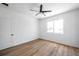 Bright bedroom featuring wood floors, ceiling fan, and ample natural light from the large window at 2608 W Columbus Dr # 1, Tampa, FL 33607