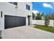 Modern home featuring a large garage, clean lines, and well-maintained landscaping at 2608 W Columbus Dr # 1, Tampa, FL 33607