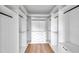 Bright walk-in closet with custom white shelving and drawers, offering ample storage space at 2608 W Columbus Dr # 1, Tampa, FL 33607
