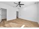 Bedroom with wood-look floors, white walls and trim, with access to closet and bathroom at 2608 W Columbus Dr # 3, Tampa, FL 33607