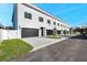 Row of modern townhomes featuring dark garage doors, white exteriors, and street views at 2608 W Columbus Dr # 4, Tampa, FL 33607