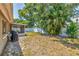 Spacious backyard with a covered patio, lush greenery, and privacy fence at 2933 Stratford Dr, Largo, FL 33771