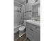 Bathroom features modern vanity with new tile and shower with a shower curtain at 2933 Stratford Dr, Largo, FL 33771
