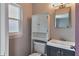 Charming bathroom features a vanity with storage, a toilet, and a bright window at 2933 Stratford Dr, Largo, FL 33771