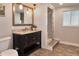 Bathroom featuring a dark vanity with granite countertop, a framed mirror, and a tiled shower at 2933 Stratford Dr, Largo, FL 33771