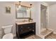 Bathroom featuring a dark vanity with granite countertop, a framed mirror, and a tiled shower at 2933 Stratford Dr, Largo, FL 33771
