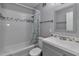 Bathroom featuring tiled walls, a shower-tub combo, and a single sink vanity at 2933 Stratford Dr, Largo, FL 33771