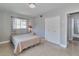 Bedroom featuring a comfortable bed, a closet, and access to the en-suite bathroom at 2933 Stratford Dr, Largo, FL 33771