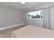 Bedroom featuring a comfortable bed, and large windows with patterned curtains at 2933 Stratford Dr, Largo, FL 33771